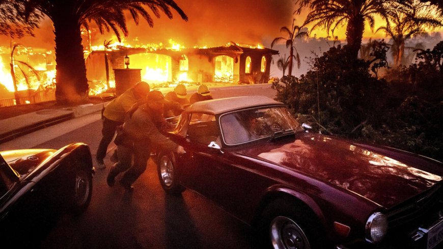 Thousands ordered to evacuate as powerful wind-fed wildfire burns homes in Southern California