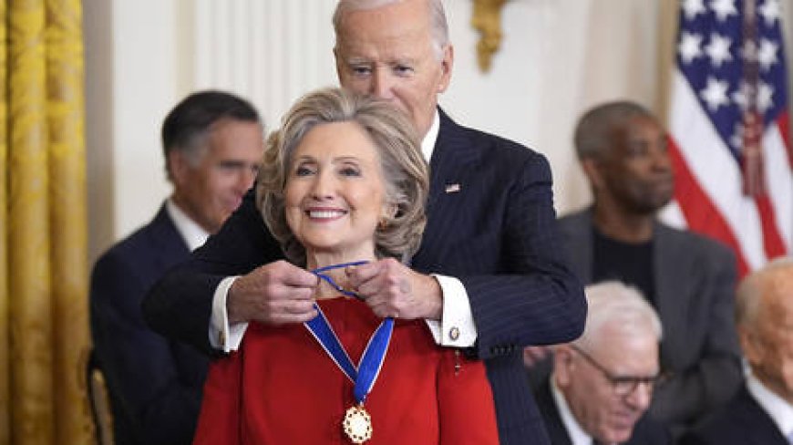 Biden hands top US honor to Clinton and Soros