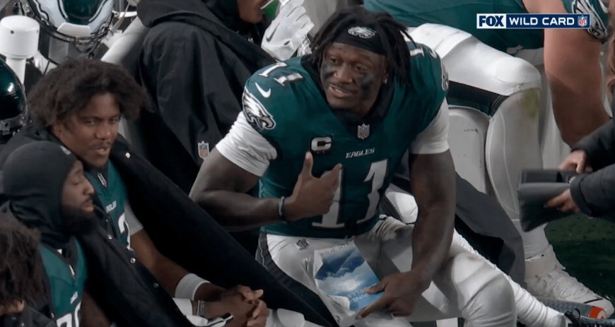 Cameras capture odd moment between Eagles star receiver reading a book while on the bench during playoff game